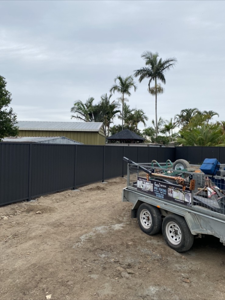 Long black Colorbond fence on a cleared block